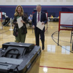 
              Republican gubernatorial candidate businessman Chris Doughty, right, and his wife Leslie, left, prepare to cast their ballots, Tuesday, Sept. 6, 2022, in Wrentham, Mass., while voting in the state's primary election. Doughty, a political newcomer, is going up against Republican Geoff Diehl who has former President Donald Trump's endorsement. (AP Photo/Steven Senne)
            