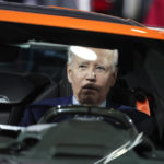 
              President Joe Biden sits in a Corvette during a tour of the Detroit Auto Show, Wednesday, Sept. 14, 2022, in Detroit. (AP Photo/Evan Vucci)
            