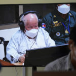 
              Khieu Samphan, former Khmer Rouge head of state, is seen on screen at the court's press center during a hearing at the U.N.-backed war crimes tribunal in Phnom Penh, Cambodia, Thursday, Sept. 22, 2022. The tribunal will issue its ruling on an appeal by Khieu Samphan, the last surviving leader of the Khmer Rouge government that ruled Cambodia from 1975-79. He was convicted in 2018 of genocide, crimes against humanity and war crimes and sentenced to life in prison. (AP Photo/Heng Sinith)
            