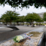
              A flower is visible on one of the benches at the National 9/11 Pentagon Memorial outside the Pentagon in Washington, Sunday, Sept. 11, 2022, on the morning of the 21st anniversary of the 9/11 terrorist attacks. (AP Photo/Andrew Harnik)
            