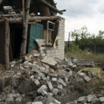 
              A man walks past a damaged buidling of his house after a Russian attack days ago in Raihorodok, Ukraine, Monday, Sept. 26, 2022. (AP Photo/Leo Correa)
            