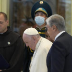 
              Pope Francis, left, meets the Kazakhstan's President Kassym-Jomart Tokayev as he arrives at Our-Sultan's International airport in Nur-Sultan, Kazakhstan, Tuesday, Sept. 13, 2022. Pope Francis begins a 3-days visit to the majority-Muslim former Soviet republic to minister to its tiny Catholic community and participate in a Kazakh-sponsored conference of world religious leaders. (AP Photo/Andrew Medichini)
            