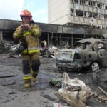 
              FILE - A firefighter walks at the scene of a building that was damaged by a deadly Russian missile attack in Vinnytsia, Ukraine, July 14, 2022. Residents of Moscow-controlled regions in Ukraine are set to start voting Friday Sept. 23, 2022, on whether to join Russia in Kremlin-engineered referendums that set the stage for a sharp escalation of the nearly seven-month war. (AP Photo/Efrem Lukatsky, File)
            