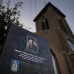 
              An information board with a photo of Henriette Hanotte stands next to the local church in the center of the town of Bachy, France, Friday, Sept. 16, 2022. Hanotte was a Belgian resistance member during World War II and from the age of nineteen aided the escape of nearly 140 airmen from occupied Belgium into France as part of the Comet Line. (AP Photo/Virginia Mayo)
            
