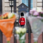 
              Boquet's of flowers are left on the gate at Buckingham Palace, London, following the death of Queen Elizabeth II, Friday Sept. 9, 2022. The country began a 10-day mourning period Friday, with bells tolling around Britain and 96 gun salutes planned in London – one for each year of the queen’s long life. People around the globe gathered at British embassies to pay homage to the queen, who died Thursday in Balmoral Castle in Scotland. (Kirsty O'Connor/PA Wire/PA via AP)
            