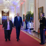 
              President Joe Biden arrives with Susan Bro, mother of Heather Heyer who was killed in 2017 during a white supremacist rally, during the United We Stand Summit in the East Room of the White House in Washington, Thursday, Sept. 15, 2022. The summit is aimed at combating a spate of hate-fueled violence in the U.S., as he works to deliver on his campaign pledge to "heal the soul of the nation." (AP Photo/Susan Walsh)
            