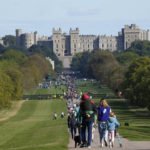 
              People make their way along the Long Walk towards Cambridge gate outside Windsor Castle to lay flowers for the late Queen Elizabeth II in Windsor, England, Sunday, Sept. 18, 2022. The Queen will lie in state in Westminster Hall for four full days before her funeral on Monday Sept. 19. (AP Photo/Gregorio Borgia)
            