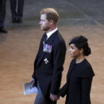 
              Britain's Prince Harry and Meghan, Duchess of Sussex, walk inside Westminster Hall in London, Wednesday, Sept. 14, 2022. The Queen will lie in state in Westminster Hall for four full days before her funeral on Monday Sept. 19. (Phil Noble/Pool Photo via AP)
            
