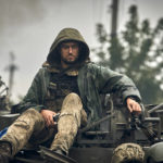 
              A Ukrainian soldier atop a military vehicle on the road in the freed territory of the Kharkiv region, Ukraine, Monday, Sept. 12, 2022. Ukrainian troops retook a wide swath of territory from Russia on Monday, pushing all the way back to the northeastern border in some places, and claimed to have captured many Russian soldiers as part of a lightning advance that forced Moscow to make a hasty retreat. (AP Photo/Kostiantyn Liberov)
            