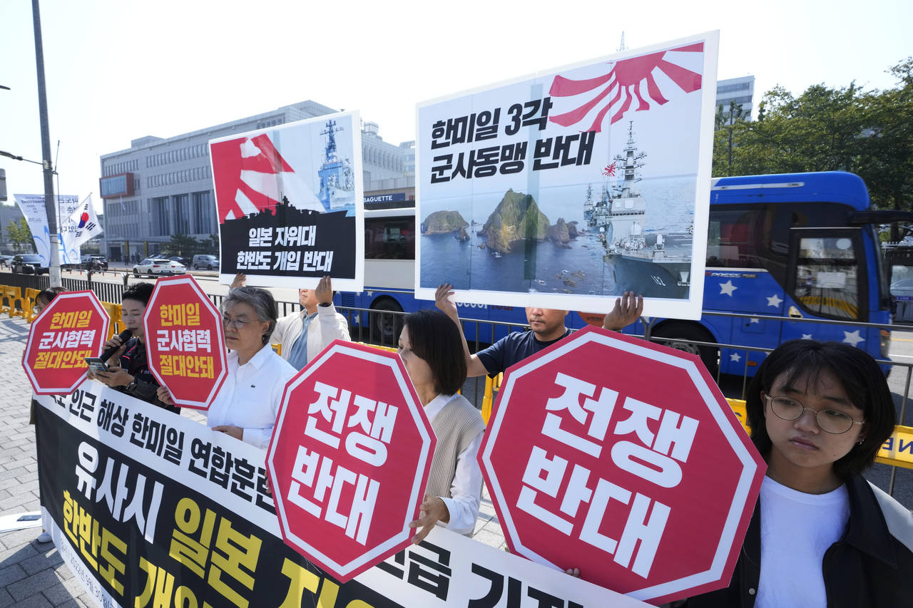 Protesters stage a rally to oppose the joint naval exercises between South Korea, U.S. and Japan in...
