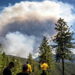 
              Firefighters in the Foresthill community of Placer County, Calif., watch the as a plume rises from the Mosquito Fire on Thursday, Sept. 8, 2022. (AP Photo/Noah Berger)
            