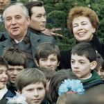 
              FILE - Soviet leader Mikhail Gorbachev with his wife Raisa pose with a group of young Yugoslavian school children after they attended a tree planting ceremony at the Park of Friendship near Belgrade, March 15, 1988. The Soviet pair are on an official visit to Yugoslavia. When Mikhail Gorbachev is buried Saturday at Moscow's Novodevichy Cemetery, he will once again be next to his wife, Raisa, with whom he shared the world stage in a visibly close and loving marriage that was unprecedented for a Soviet leader. Gorbachev's very public devotion to his family broke the stuffy mold of previous Soviet leaders, just as his openness to political reform did. (AP Photo, File)
            