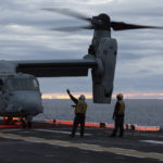
              Deck personnel gives signals to a MV-22 Osprey, assault support aircraft for the U.S. Marine Corps, after landing on the flight deck of the Wasp-class amphibious assault ship USS Kearsarge (LHD 3), operating in the Baltic Sea, Friday, Sept. 2, 2022. Amid Russia's war on Ukraine and tensions in the Baltic Sea region, USS Kearsarge is the first U.S. Navy amphibious assault ship in at least 20 years to be taking part in international training in the Baltic. (AP Photo/Michal Dyjuk)
            
