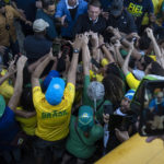 
              President Jair Bolsonaro greets supporters in Copacabana beach during the celebrations of the bicentennial of the country's independence in Rio de Janeiro, Brazil, Wednesday, Sept. 7, 2022. (AP Photo/Rodrigo Abd)
            