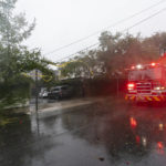 
              A firetruck departs after marking low hanging wires as the effects from Hurricane Ian are felt, Friday, Sept. 30, 2022, in Charleston, S.C. (AP Photo/Alex Brandon)
            