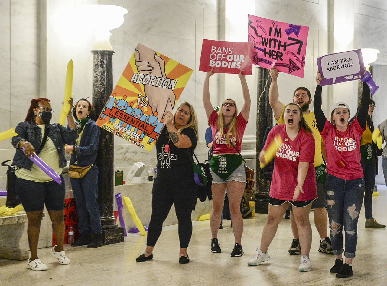 Abortion rights supporters demonstrate outside the Senate chamber at the West Virginia state Capito...