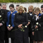 
              First lady Jill Biden participates in a moment of silence with the members of the Association of Flight Attendants at the Flight 93 National Memorial Wall of Names following a ceremony commemorating the 21st anniversary of the Sept. 11, 2001 terrorist attacks in Shanksville, Pa., Sunday, Sept. 11, 2022. (AP Photo/Barry Reeger)
            