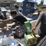 
              FILE - A group of community members, from left, Suzana Perez, Maricella Perez, Gavino Vasquez and Francisco Ramos hand out water, ice, popsicles and Gatorade to individuals experiencing homelessness, during a heat wave on Sept. 5, 2022, in Santa Rosa, Calif.  Ten years ago scientists warned the world about how climate change would amplify extreme weather disasters. There are now deadly floods, oppressive heat waves, killer storms, devastating droughts and what scientists call unprecedented extremes as predicted in 2012. (Kent Porter/The Press Democrat via AP, File)
            