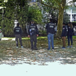 
              Police stand inside the gated grounds of a home linked to Viktor Vekselberg, in Southampton, on New York's Long Island, Thursday Sept. 1, 2022. U.S. federal agents on Thursday simultaneously searched properties in Manhattan, the posh beach community of Southampton, N.Y., and on an exclusive Miami island that have been linked to a billionaire Russian oligarch whose $120 million yacht was seized in April. (John Roca/Newsday via AP)
            