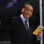 
              Silvio Berlusconi, leader of center-right, populist Forza Italia comes out of a voting booth before casting his ballot  at a polling station in Milan, Italy, Sunday, Sept. 25, 2022. Just in time to celebrate his 86th birthday, Italy’s former premier Silvio Berlusconi is making his return to Italy's parliament, winning a seat in the Senate nearly a decade after being banned from public office over a tax fraud conviction. (AP Photo/Antonio Calanni, File )
            