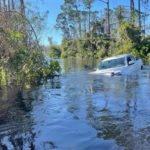 
              A car is submerged in flood water in North Port, Fla., on Friday, Sept. 30, 2022. (AP Photo/Adriana Gomez Licon)
            