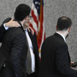 
              Derrel McDavid, center, hugs his attorney as he walks into the Dirksen Federal Courthouse in Chicago after verdicts were reached in R. Kelly's trial, Two Kelly associates, Derrel McDavid and Milton Brown, are co-defendants. McDavid is accused of helping Kelly fix the 2008 trial, Wednesday, Sept. 14, 2022, in Chicago. A federal jury on Wednesday convicted R. Kelly of several child pornography and sex abuse charges in his hometown of Chicago, delivering another legal blow to a singer who used to be one of the biggest R&B stars in the world. (AP Photo/Matt Marton)
            