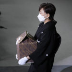 
              Akie Abe, wife of former Prime Minister Shinzo Abe, carries a cinerary urn containing his ashes at his state funeral, Tuesday, Sept. 27, 2022, in Tokyo. Abe was assassinated in July. (Franck Robichon/Pool photo via AP)
            