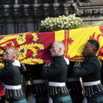 
              The coffin of Britain's Queen Elizabeth II is carried into St Giles' Cathedral, Edinburgh, Scotland, Monday Sept. 12, 2022. King Charles III arrived in Edinburgh on Monday to accompany his late mother’s coffin on an emotion-charged procession through the historic heart of the Scottish capital to the cathedral where it will lie for 24 hours to allow the public to pay their last respects. (Jacob King/Pool via AP)
            