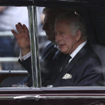
              King Charles III waves as he arrives at Buckingham Palace ahead of the ceremonial procession of the coffin of Queen Elizabeth II, from Buckingham Palace to Westminster Hall, in London, Wednesday Sept. 14, 2022. The Queen will lie in state in Westminster Hall for four full days before her funeral on Monday Sept. 19. (Tom Nicholson/Pool Photo via AP)
            