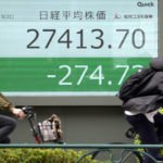 
              People wearing protective masks ride bicycle in front of an electronic stock board showing Japan's Nikkei 225 index at a securities firm Wednesday, Sept. 21, 2022, in Tokyo. Asian shares mostly declined Wednesday as investors looked ahead to a widely expected interest rate hike by the U.S. Federal Reserve in its bid to squash the highest inflation in decades.(AP Photo/Eugene Hoshiko)
            