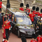 
              The coffin proceeds to St. George's Chapel at Windsor Castle, Windsor, England, Monday Sept. 19, 2022, ahead of the committal service for Queen Elizabeth II. The Queen, who died aged 96 on Sept. 8, will be buried at Windsor alongside her late husband, Prince Philip, who died last year. (Ryan Pierse/Pool via AP)
            