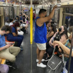 
              FILE — Commuters wear face masks while riding the subway in New York, June 6, 2021. New York state is dropping its mask requirement on public transportation thanks in part to the availability of new booster shots targeting the most common strain of COVID-19, Gov. Kathy Hochul announced Wednesday, Sept. 7, 2022. (AP Photo/Ted Shaffrey, File)
            