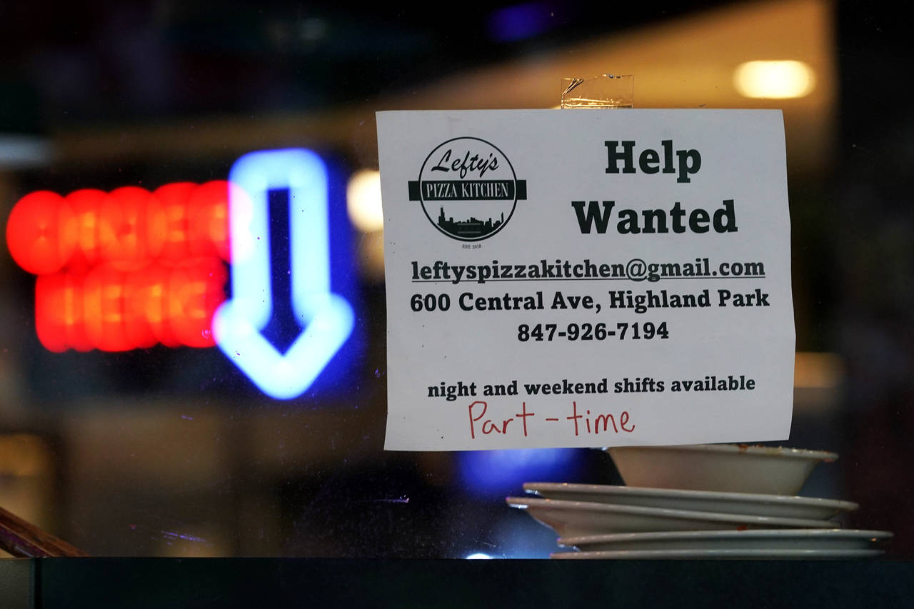 Hiring sign is displayed at a restaurant in Highland Park, Ill., Thursday, July 14, 2022.  The nati...