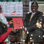 
              Kenya's new president William Ruto, right, accompanied by Kenya's Supreme Court Chief Justice Martha Koome, is sworn in to office at a ceremony held at Kasarani stadium in Nairobi, Kenya Tuesday, Sept. 13, 2022. William Ruto was sworn in as Kenya's president on Tuesday after narrowly winning the Aug. 9 election and after the Supreme Court last week rejected a challenge to the official results by losing candidate Raila Odinga. (AP Photo/Brian Inganga)
            