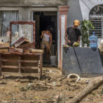 
              Neighbors work to recover their belongings after the flooding caused by Hurricane Fiona in the Los Sotos neighborhood of Higüey, Dominican Republic, Tuesday, Sept. 20, 2022. (AP Photo/Ricardo Hernandez)
            