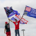 
              Supporters wave flags as they wait in line outside a political rally in Wilkes-Barre, Pa., Saturday, Sept. 3, 2022. (AP Photo/Mary Altaffer)
            