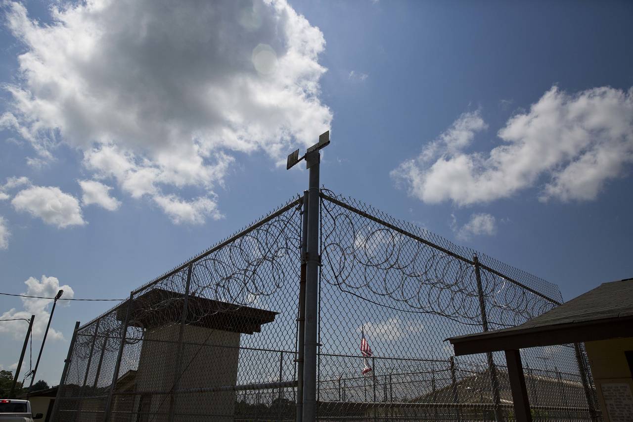 FILE - A fence stands at Elmore Correctional Facility in Elmore, Ala., June 18, 2015. Alabama inmat...