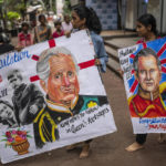 
              Students of Mumbai's Gurukul art school carry their art works congratulating Britain’s new monarch King Charles III in Mumbai, India, Sunday, Sept. 11, 2022. King Charles III was formally proclaimed sovereign of the United Kingdom on Saturday following the death of his mother, Queen Elizabeth II on Thursday. (AP Photo/Rafiq Maqbool)
            