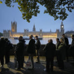 
              People queue to pay their respect to the late Queen Elizabeth II during the Lying-in State, at Westminster Hall in London, Thursday, Sept. 15, 2022. The Queen will lie in state in Westminster Hall for four full days before her funeral on Monday Sept. 19. (AP Photo/Markus Schreiber)
            