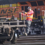 
              A worker rides a rail car at a BNSF rail crossing in Saginaw, Texas, Wednesday, Sept. 14, 2022. Business and government officials are preparing for a potential nationwide rail strike at the end of this week while talks carry on between the largest U.S. freight railroads and their unions. (AP Photo/LM Otero)
            