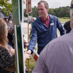 
              New Hampshire Republican 1st Congressional District Candidate Matt Mowers greets campaign volunteers, Tuesday, Sept. 13, 2022, during a campaign stop at a polling station in Derry, N.H. (AP Photo/Charles Krupa)
            