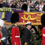 
              Grenadier Guards flank the coffin of Queen Elizabeth II during a procession from Buckingham Palace to Westminster Hall in London, Wednesday, Sept. 14, 2022. The Queen will lie in state in Westminster Hall for four full days before her funeral on Monday Sept. 19. (AP Photo/Kirsty Wigglesworth)
            