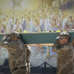 
              Soldiers carry a coffin of their comrade, a Ukrainian military officer killed during fighting against Russians, during his funeral at St Michael cathedral in Kyiv, Ukraine, Thursday, Sept. 8, 2022. U.S. Secretary of State Antony Blinken on Thursday announced major new military aid worth more than 2 billion dollars for Ukraine and other European countries threatened by Russia. (AP Photo/Efrem Lukatsky)
            