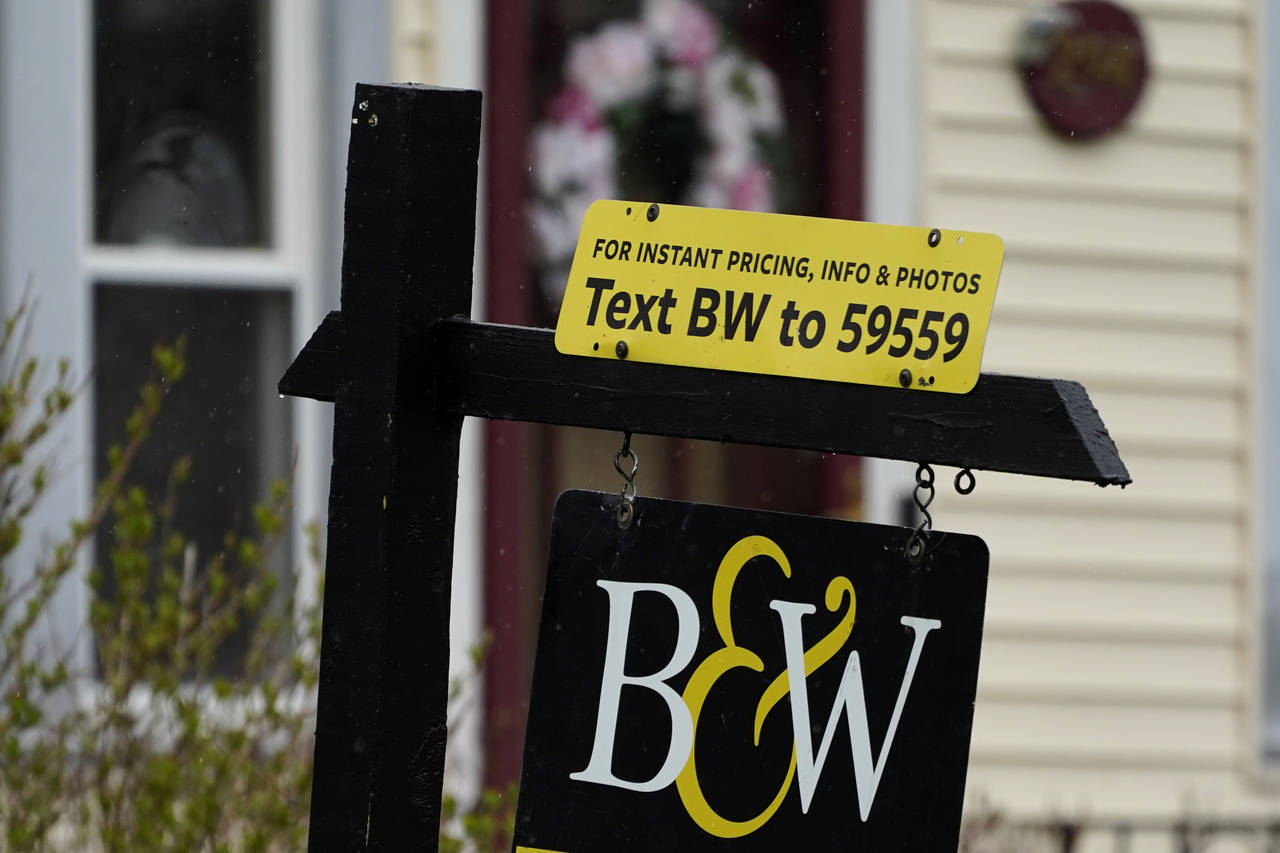 FILE - A sign is displayed outside a home in Wheeling, Ill., May 5, 2022. Average long-term U.S. mo...