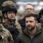 
              Ukrainian President Volodymyr Zelenskyy poses for a photo with soldiers after attending a national flag-raising ceremony in the freed Izium, Ukraine, Wednesday, Sept. 14, 2022. Zelenskyy visited the recently liberated city on Wednesday, greeting soldiers and thanking them for their efforts in retaking the area, as the Ukrainian flag was raised in front of the burned-out city hall building. (AP Photo/Leo Correa)
            