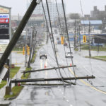 
              Downed power poles block a road in Glace Bay, Nova Scotia, on Sunday, Sept. 25, 2022. A day after post-tropical storm Fiona left a trail of destruction through Atlantic Canada and eastern Quebec, residents of a coastal town in western Newfoundland continued to pick through wreckage strewn across their community, easily the most damaged area in the region. (Vaughan Merchant/The Canadian Press via AP)
            