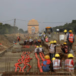 
              India Gate monument is seen behind as laborers work on the Central Vista project in New Delhi, India, July 16, 2021. On Thursday, Sept. 8, 2022, India’s Prime Minister Narendra Modi urged the country to shed its colonial ties in a ceremony to rename Rajpath, a boulevard that was once called Kingsway after King George V, Modi called it a "symbol of slavery" under the British Raj. (AP Photo/Manish Swarup)
            