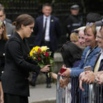
              Princess Eugenie receives a bunch of flowers from a member of the public outside the gates of Balmoral Castle in Aberdeenshire, Scotland, Saturday, Sept. 10, 2022. Queen Elizabeth II, Britain's longest-reigning monarch and a rock of stability across much of a turbulent century, died Thursday after 70 years on the throne. She was 96. (AP Photo/Alastair Grant)
            