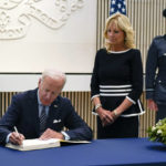 
              President Joe Biden signs a condolence book at the British Embassy in Washington, Thursday, Sept. 8, 2022, for Queen Elizabeth II, Britain's longest-reigning monarch and a rock of stability across much of a turbulent century, who died Thursday after 70 years on the throne. She was 96. First lady Jill Biden looks on at right. (AP Photo/Susan Walsh)
            