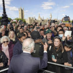 
              Britain's King Charles III meets members of the public in the queue along the South Bank, near to Lambeth Bridge as they wait to view Queen Elizabeth II lying in state ahead of her funeral on Monday, in London, Saturday, Sept. 17, 2022. (Aaron Chown/Pool Photo via AP)
            